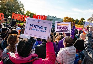 Image of women at rally holding voting signs