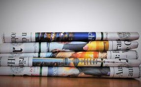 943004_840 image by kalhh from Pixabay Photograph of stack of folded newspapers
